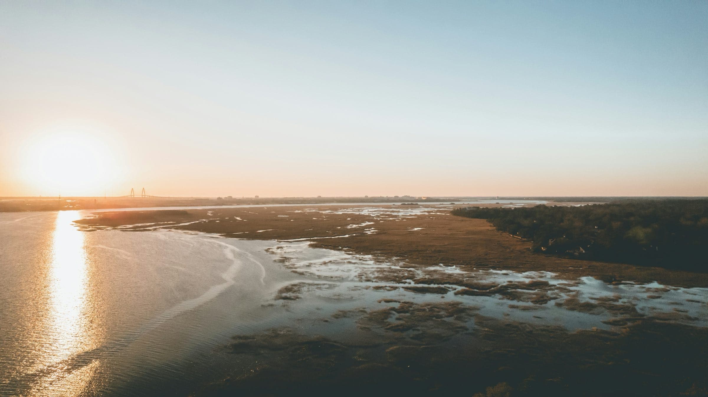 Aerial view of marsh and tidal flats at sunrise in the Charleston area