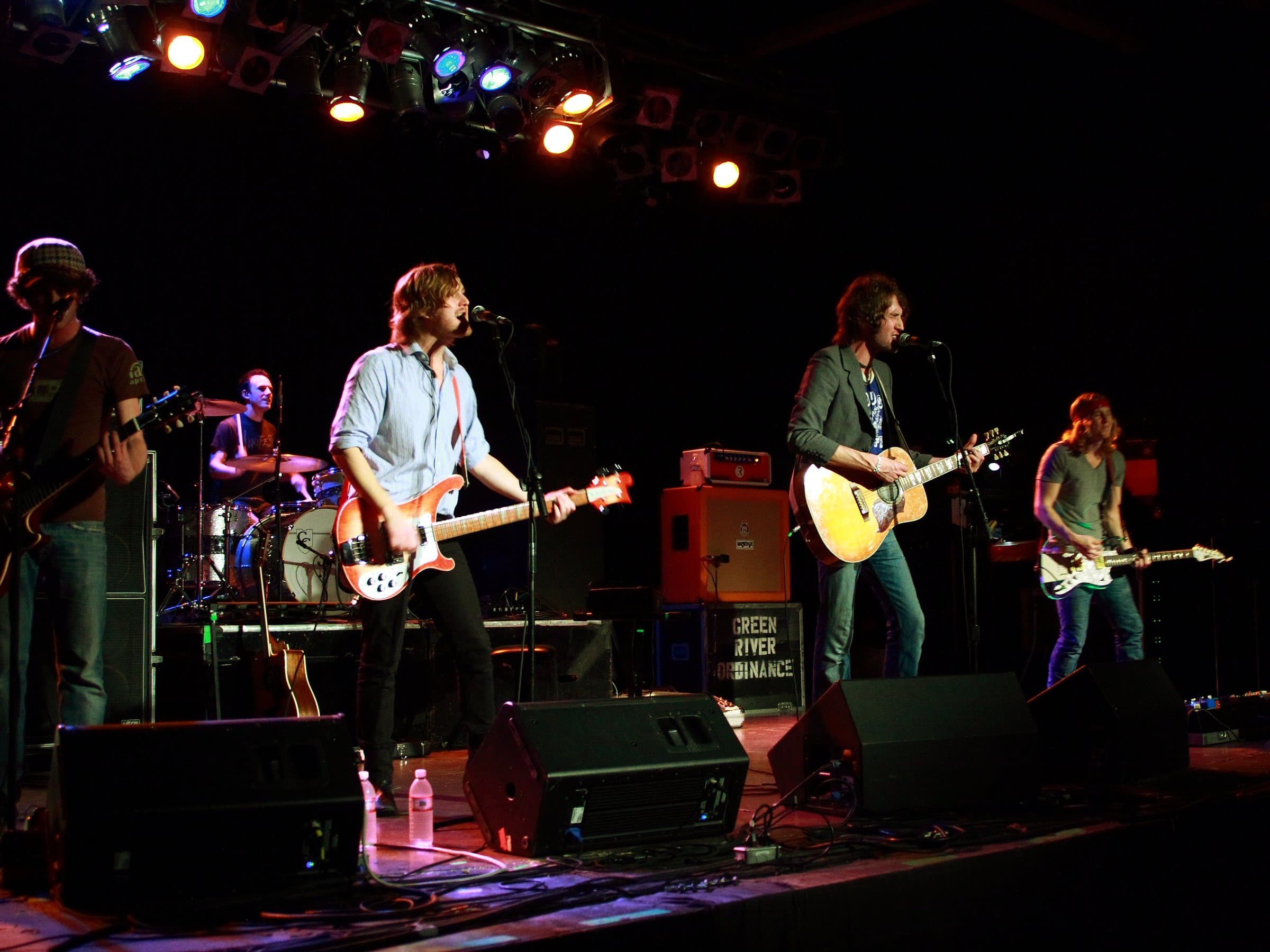 A five-piece band plays under the stage lights at Music Farm in downtown Charleston
