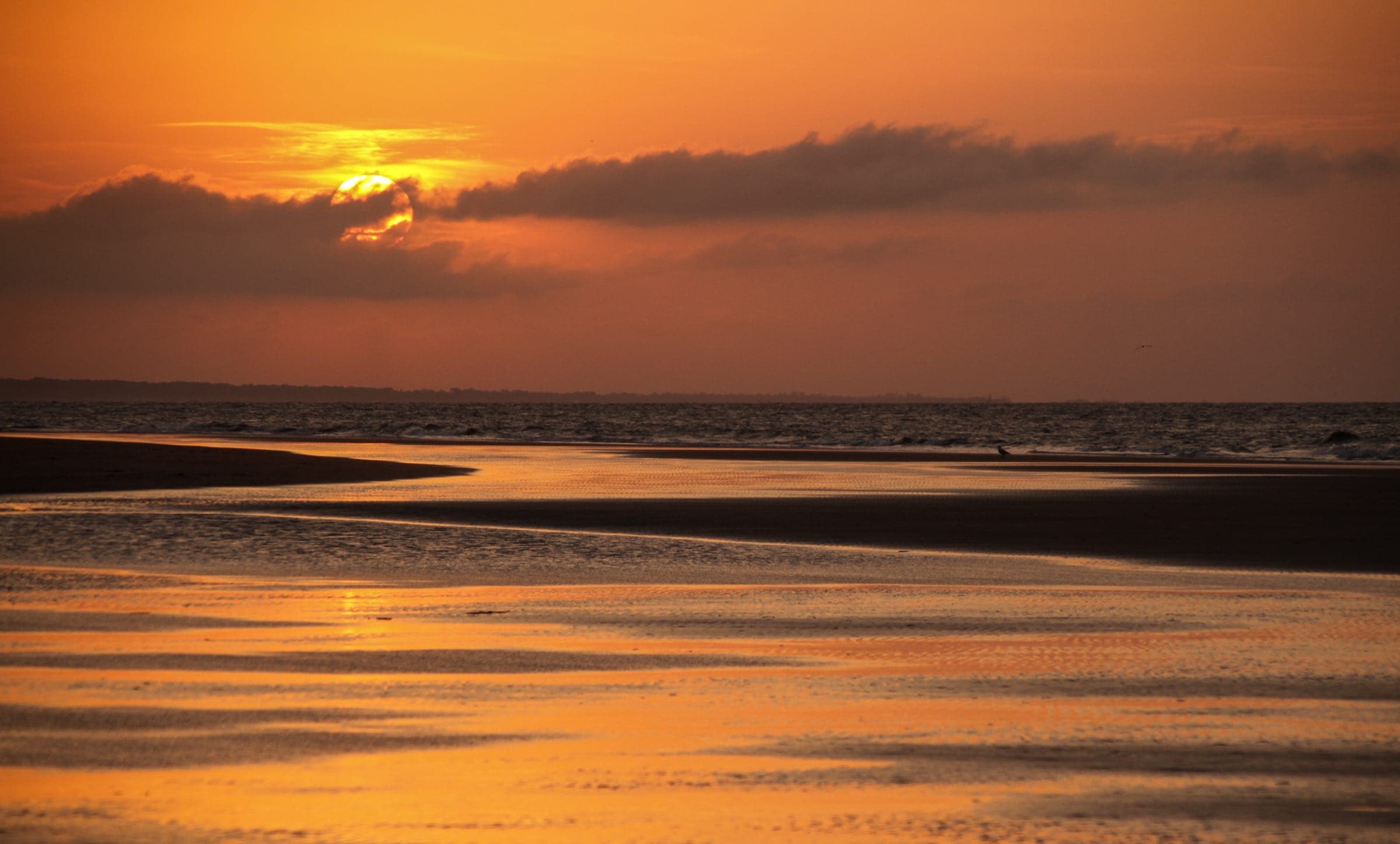 Sunrise over wet sand at low tide on Seabrook Island