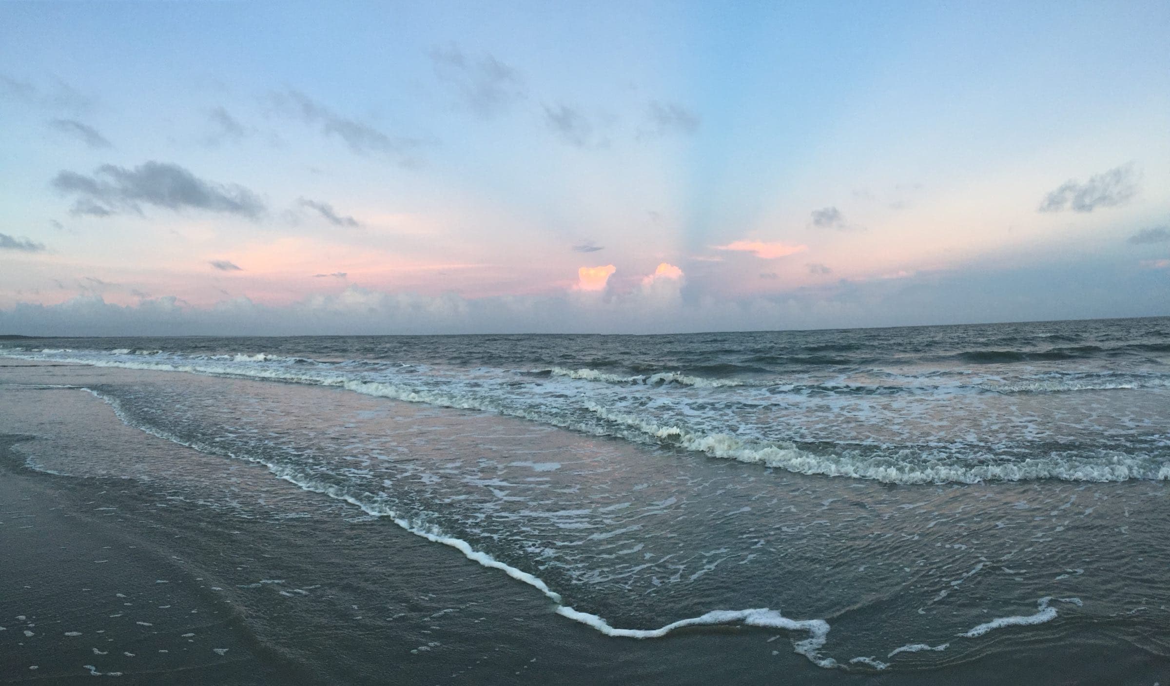 Sunrise rays over the surf on Seabrook Island