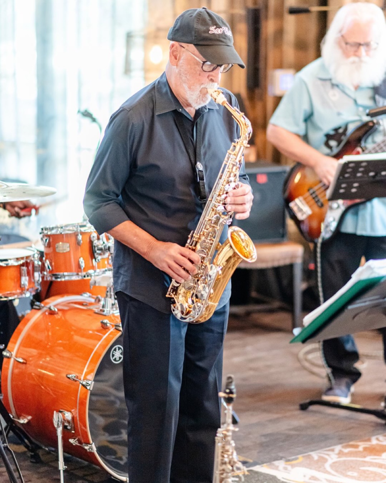A saxophone player and a bass player performing at Jazz Night at the Porch Bar at Andell Inn, Freshfields Village